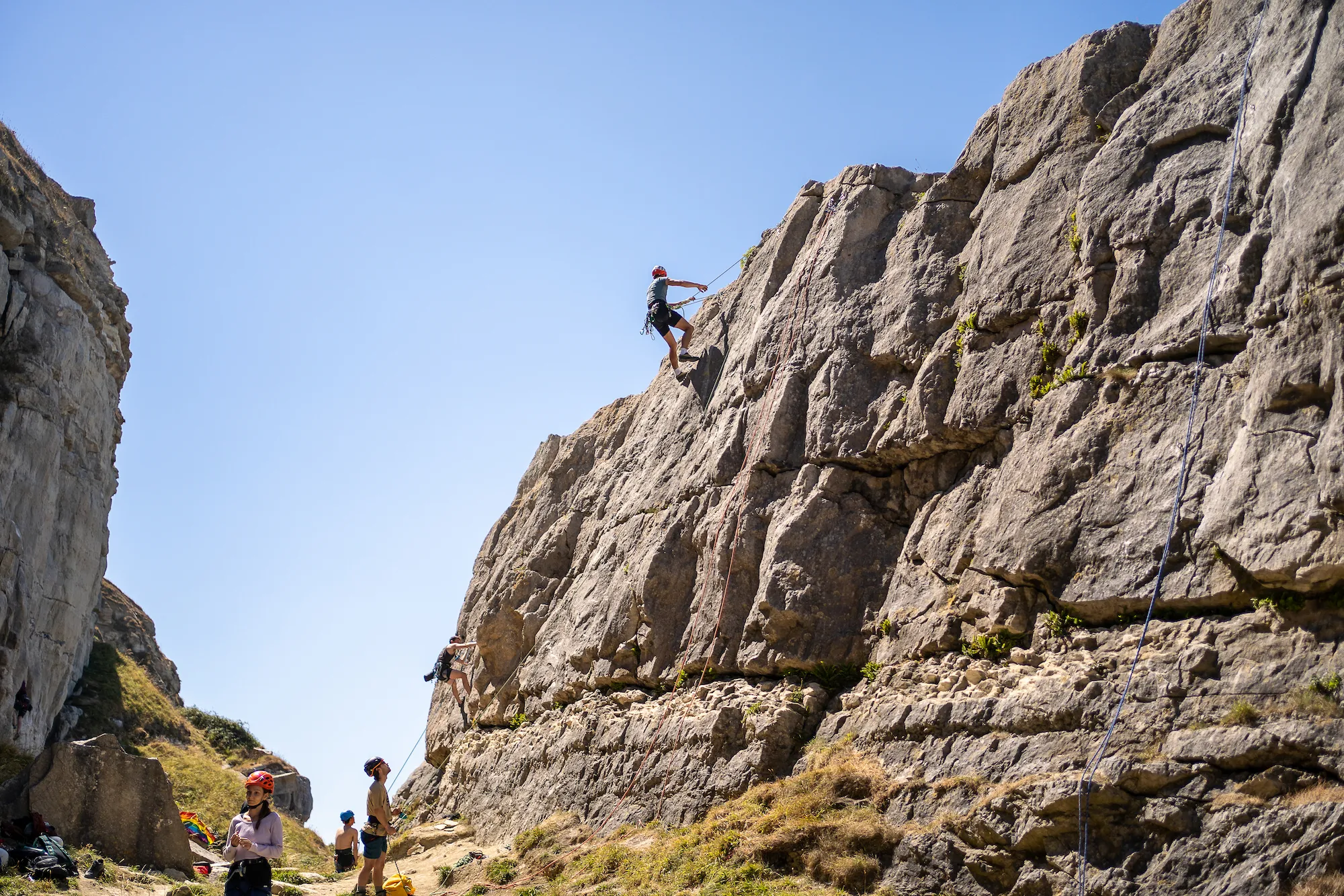 Hayden is setting up the climb at the top of the block of the Battleship crag.