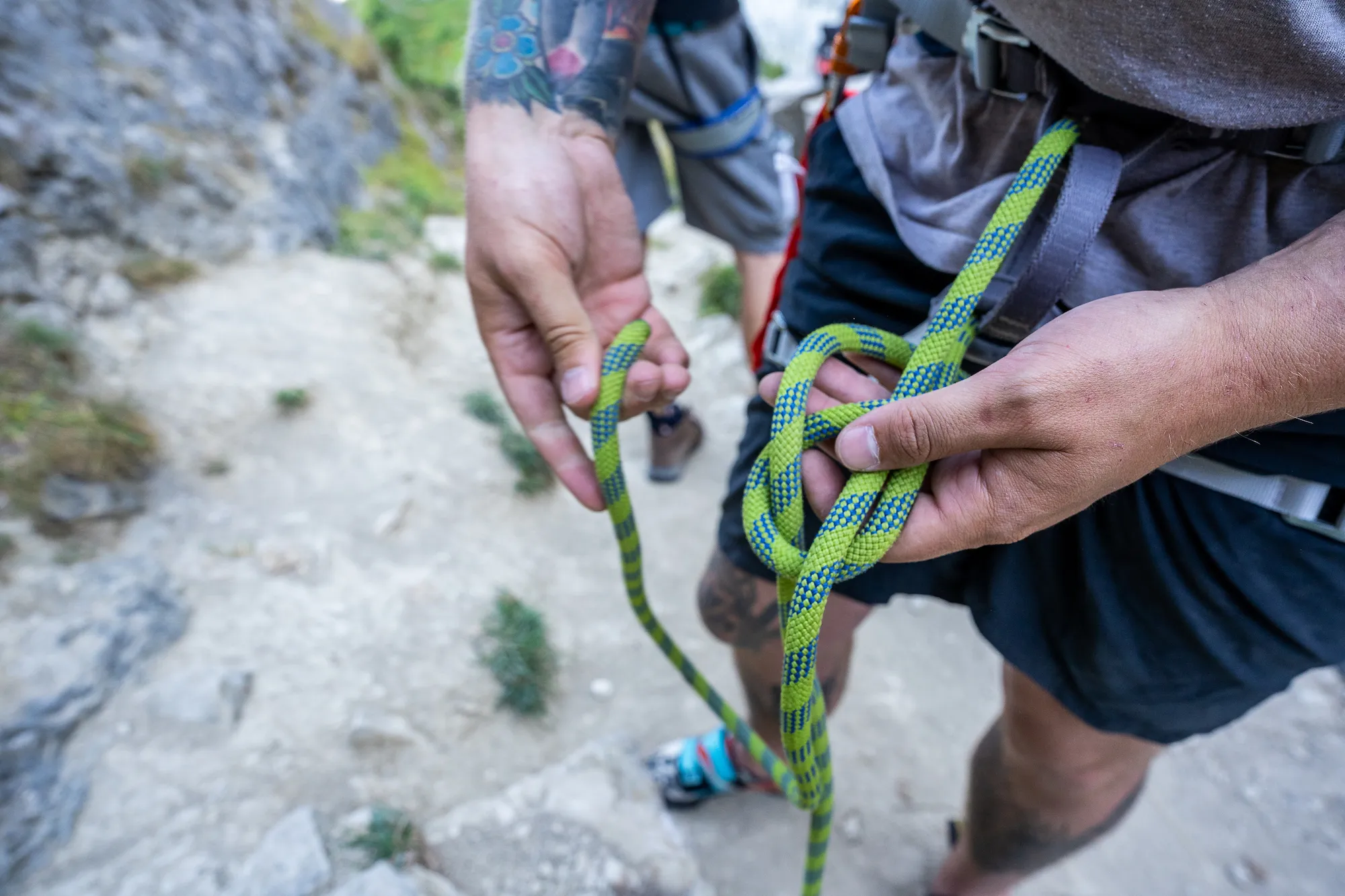 A participant learning how to rethread a figure of 8 knot, which will secure the harness.